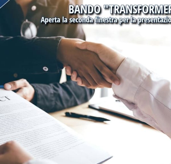 Due persone si stringono la mano durante la firma di un contratto di lavoro.