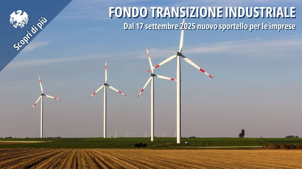 Pale eoliche in un campo agricolo, simbolo della transizione energetica sostenibile.